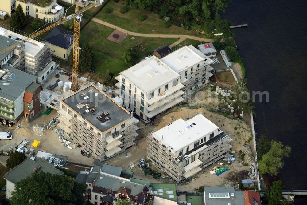 Aerial photograph Berlin - Construction site for the new building of an appartment building complex on the seafront of Mueggelsee in the Friedrichshagen part of Berlin in Germany. The compound includes three residential buildings. The building project and construction site is located right on the shores of the lake