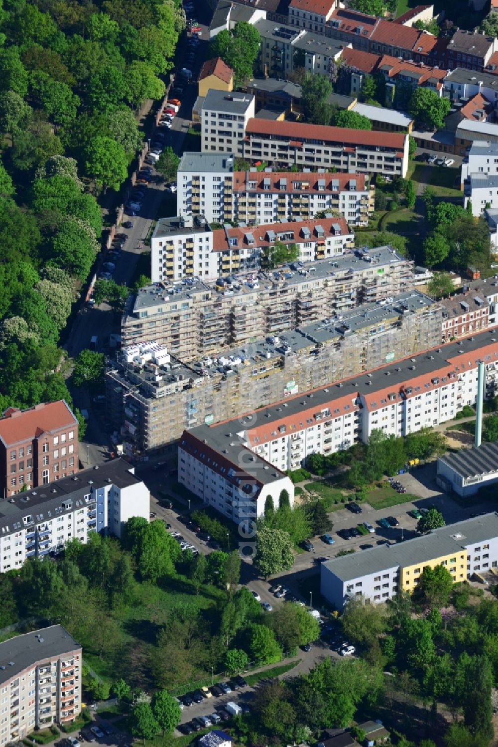 Berlin from above - Construction site for the new building of a residential area on Adlershofer Strasse in the Koepenick part of Berlin in Germany. Several residential buildings and estates are located between Adlershofer Strasse, Glienicker Strasse und Gruenauer Strasse. They are located adjacent to the park and facilities of the cemetery of the St. Laurentius community and parish