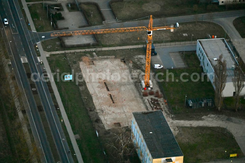 Neuruppin from above - Construction site for the multi-family residential building on Heinrich-Rau-Strasse in Neuruppin in the state Brandenburg, Germany