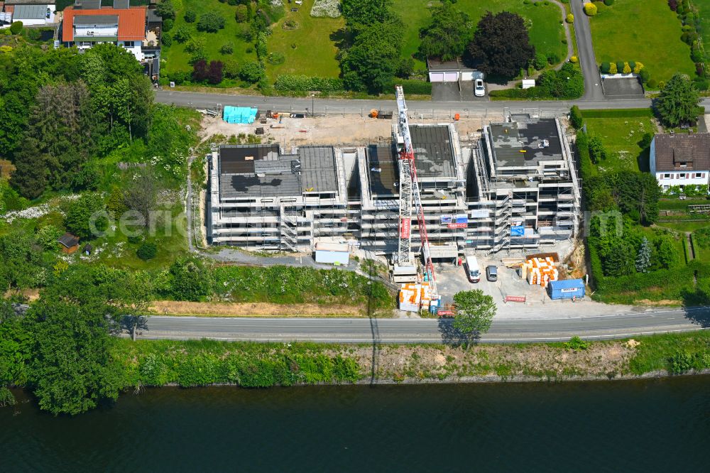 Körbecke from the bird's eye view: Construction site for the multi-family residential building on the shore of the Moehnesee on street Seeblick - Seestrasse in Koerbecke in the state North Rhine-Westphalia, Germany