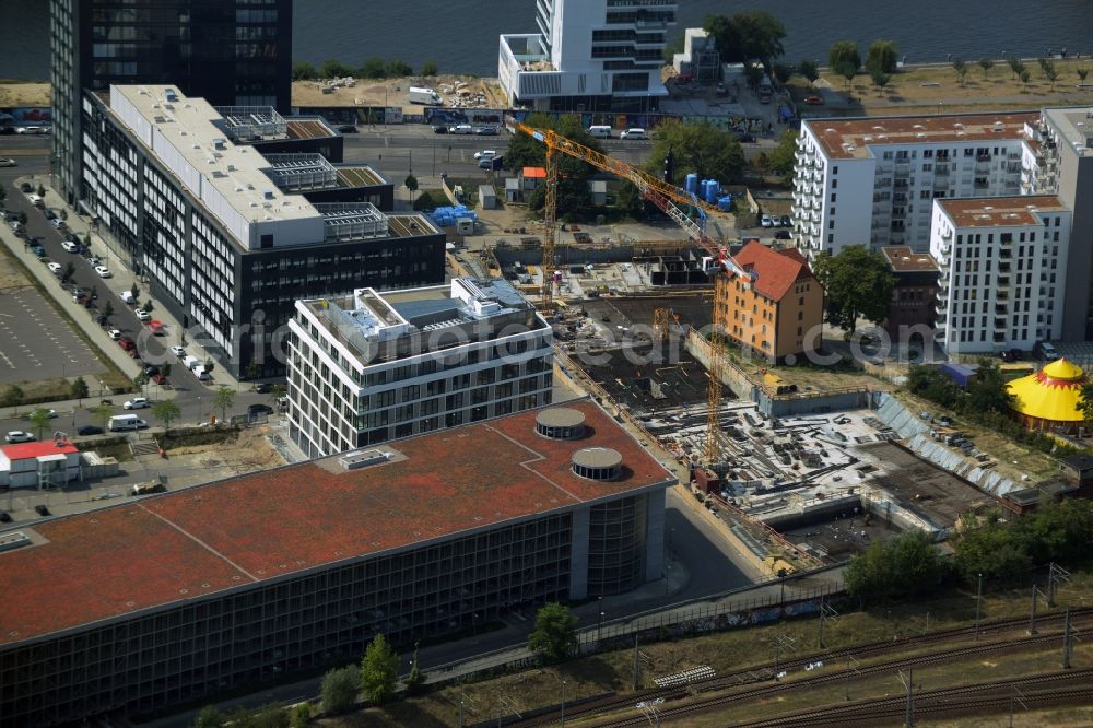 Berlin from above - Construction site of a residential high rise complex on the Northern riverbank of the river Spree in the Friedrichshain part of Berlin in Germany. The apartment buildings and towers are being built on Mariane-Von-Rantzau Strasse in close vicinity of the Mercedes Benz distribution headquarters Germany and newly built residential buildings. The two towers are a project of Wohnkompanie and are being called Max & Moritz