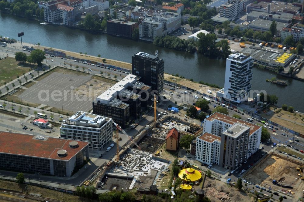 Berlin from above - Construction site of a residential high rise complex on the Northern riverbank of the river Spree in the Friedrichshain part of Berlin in Germany. The apartment buildings and towers are being built on Mariane-Von-Rantzau Strasse in close vicinity of the Mercedes Benz distribution headquarters Germany and newly built residential buildings. The two towers are a project of Wohnkompanie and are being called Max & Moritz