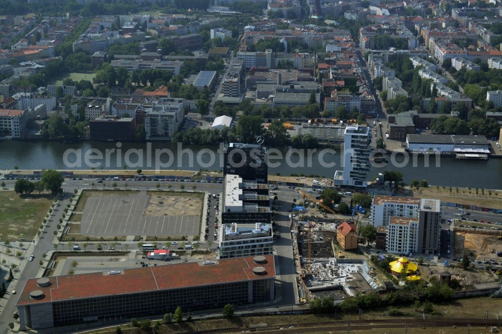 Berlin from the bird's eye view: Construction site of a residential high rise complex on the Northern riverbank of the river Spree in the Friedrichshain part of Berlin in Germany. The apartment buildings and towers are being built on Mariane-Von-Rantzau Strasse in close vicinity of the Mercedes Benz distribution headquarters Germany and newly built residential buildings. The two towers are a project of Wohnkompanie and are being called Max & Moritz