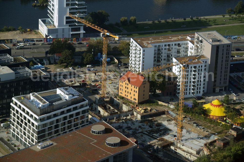 Berlin from above - Construction site of a residential high rise complex on the Northern riverbank of the river Spree in the Friedrichshain part of Berlin in Germany. The apartment buildings and towers are being built on Mariane-Von-Rantzau Strasse in close vicinity of newly built residential buildings. The two towers are a project of Wohnkompanie and are being called Max & Moritz