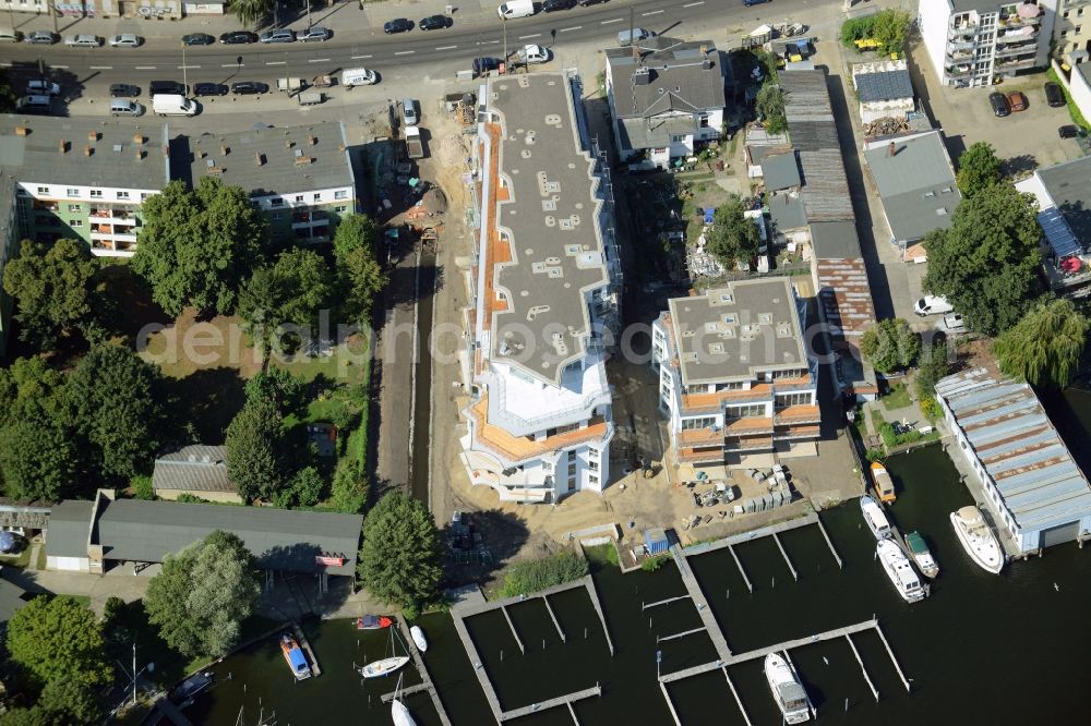 Berlin from above - Construction site for the new building of a residential complex on the Dahme riverbank in the Koepenick part of Berlin in Germany. Marina Quartier 83 with luxury appartments and balconies and terraces is being built on the riverbank