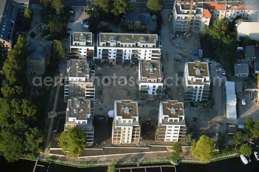 Berlin from above - Construction site for new residential construction of RESIDENTIAL QUARTER UFERKRONE at the riverside at Linden Street in Berlin Koepenick