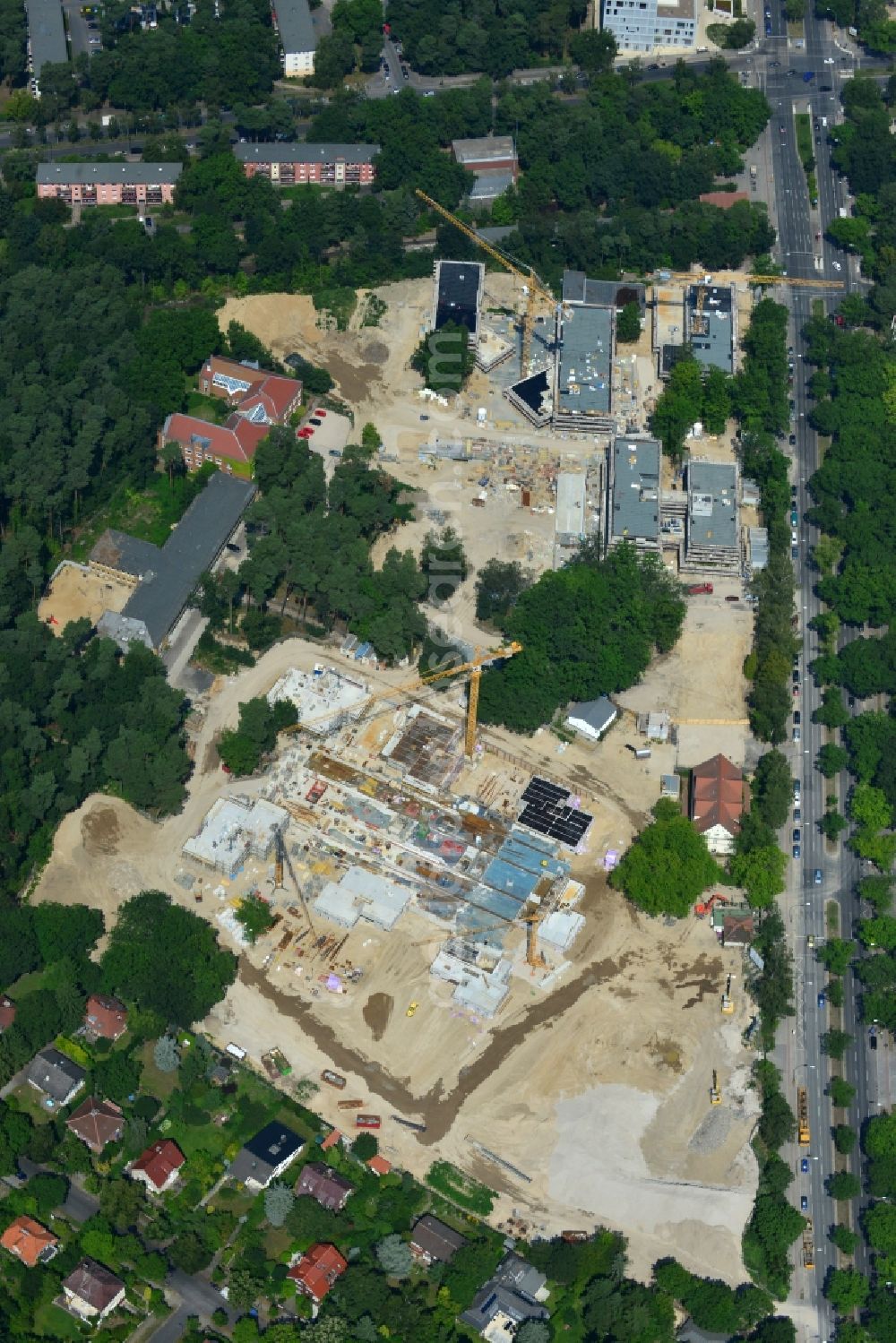 Aerial image Berlin OT Dahlem - Construction site for a residential area in Clayallee in the district of Steglitz-Zehlendorf in Berlin. The project is located on site of the former orthopedics clinic and home. The project is run by OHA Projektentwicklungsgesellschaft