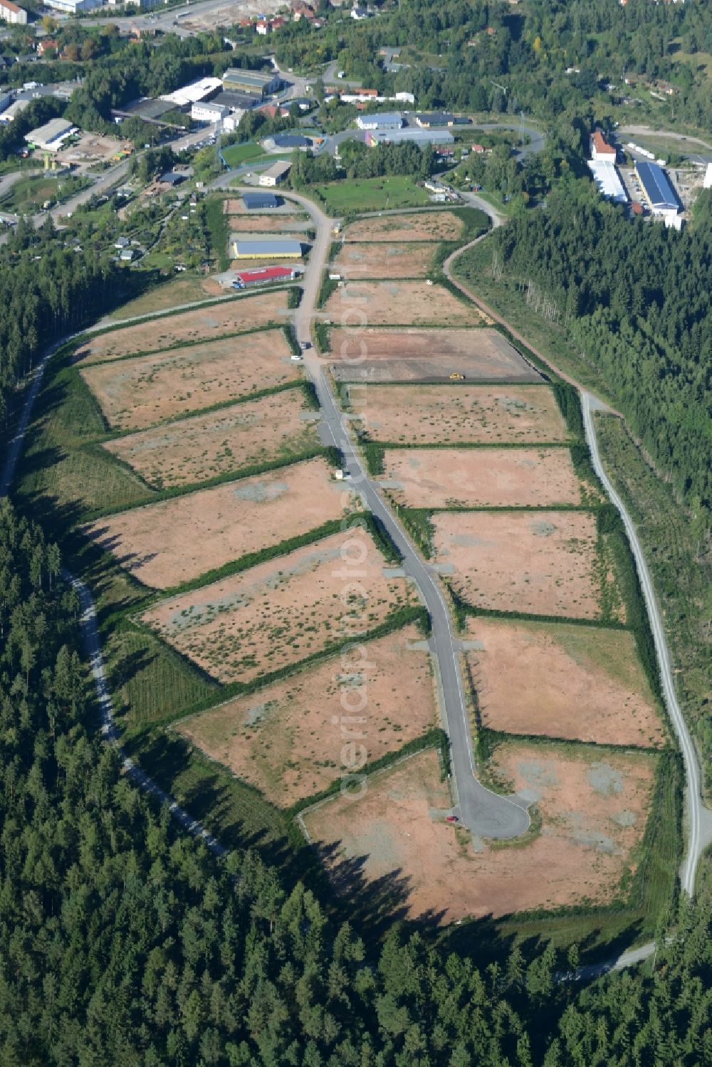 Suhl from the bird's eye view: Construction site for the new building and development of the commercial area Sehmar 2 in a forest in the South of Suhl in the state of Thuringia. Parcells and company grounds are developed