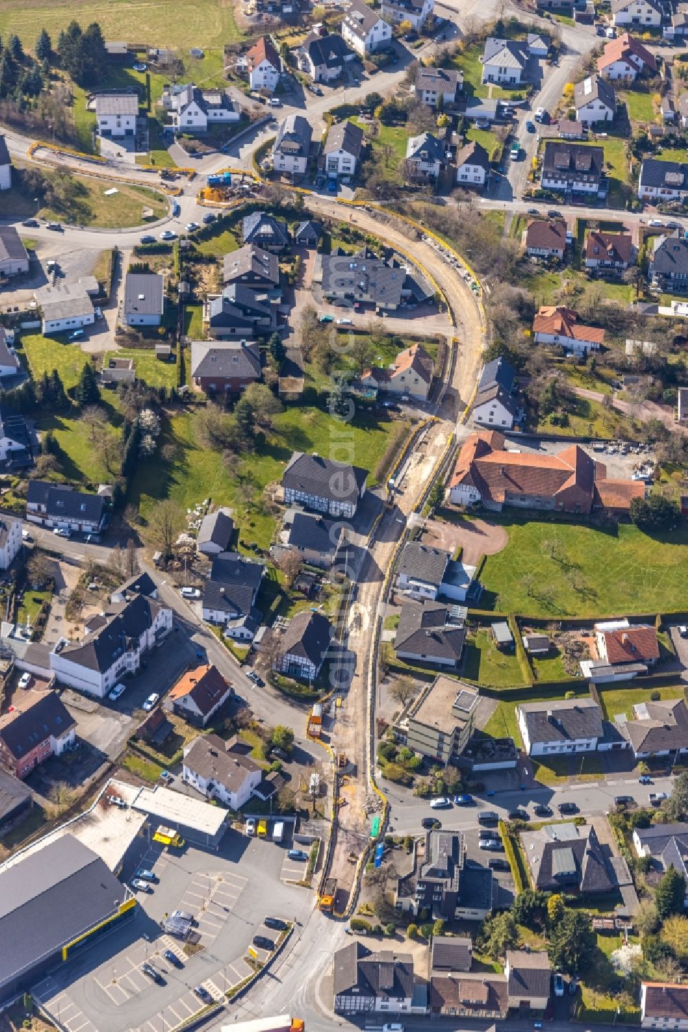 Arnsberg from the bird's eye view: Construction site for the new building and extension of the road of Wiedmannsweg in the district Herdringen in Arnsberg at Sauerland in the state North Rhine-Westphalia, Germany