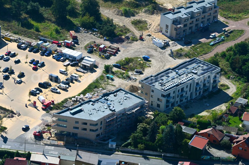 Aerial image Caputh - Construction site for the new construction of two multi-family residential buildings in the Blumenviertel on street Kirschanger in Caputh in the state Brandenburg, Germany