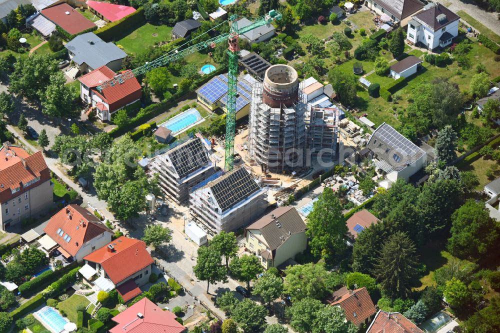 Berlin from the bird's eye view: Construction site for the construction of two new residential buildings and conversion of the water tower into a residential building on Schirnerstrasse in the district of Altglienicke in Berlin, Germany