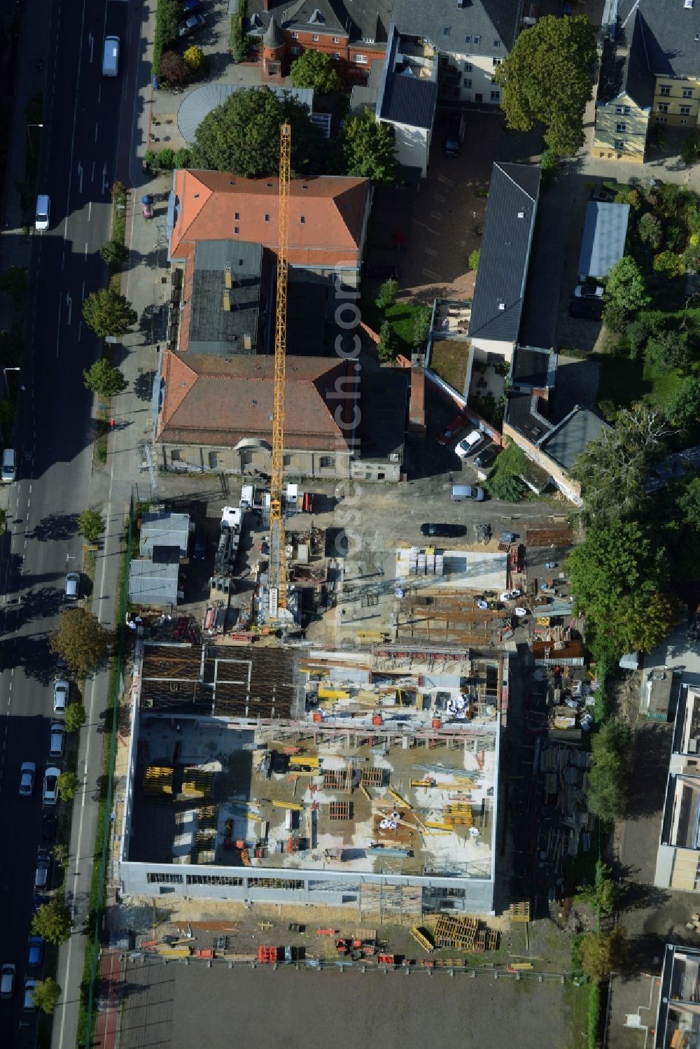 Potsdam from the bird's eye view: Construction site for the new building of a sports hall and facilities in Kurfuerstenstrasse in Potsdam in the state of Brandenburg. The project is being developed by Baurconsult and borders a historic building and sports ground