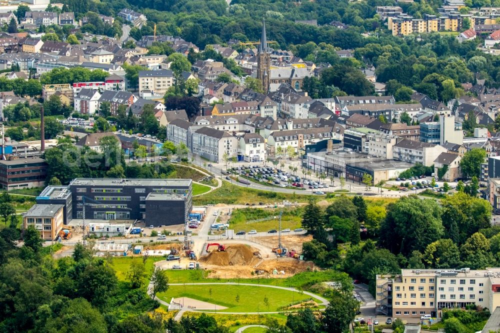 Heiligenhaus from above - Construction site of the new campus building of the Bochum University of Applied Sciences on Kettwiger Strasse in Heiligenhaus in the state of North Rhine-Westphalia. The town center with St.Suitbertus church is visible in the background