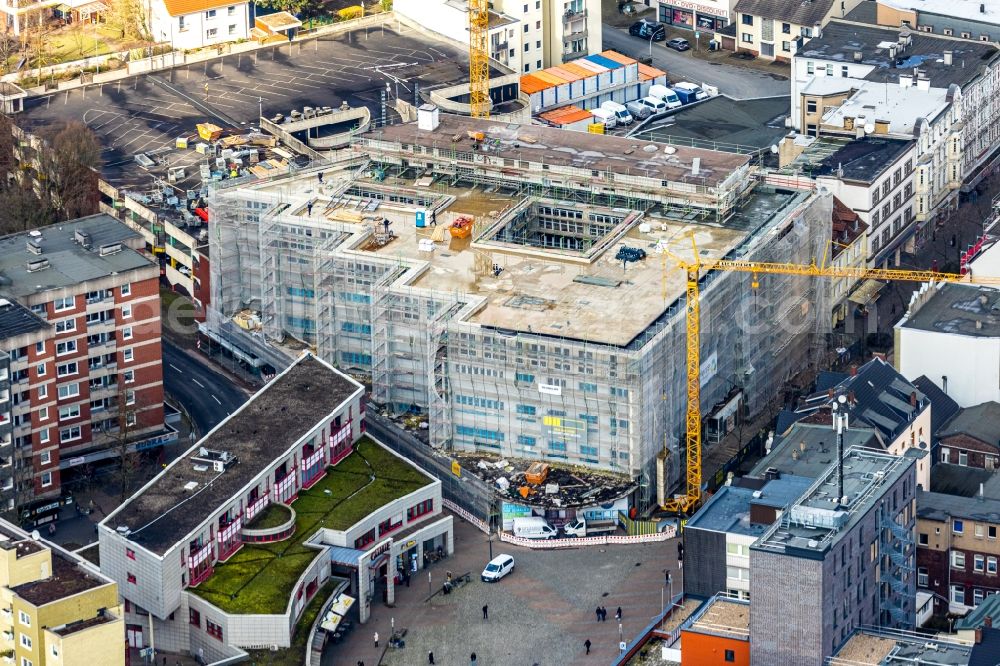 Herne from the bird's eye view: Construction site for the conversion of the former department store into an office and commercial building on Bahnhofstrasse - place Robert-Brauner-Platz in Herne in the state North Rhine-Westphalia, Germany