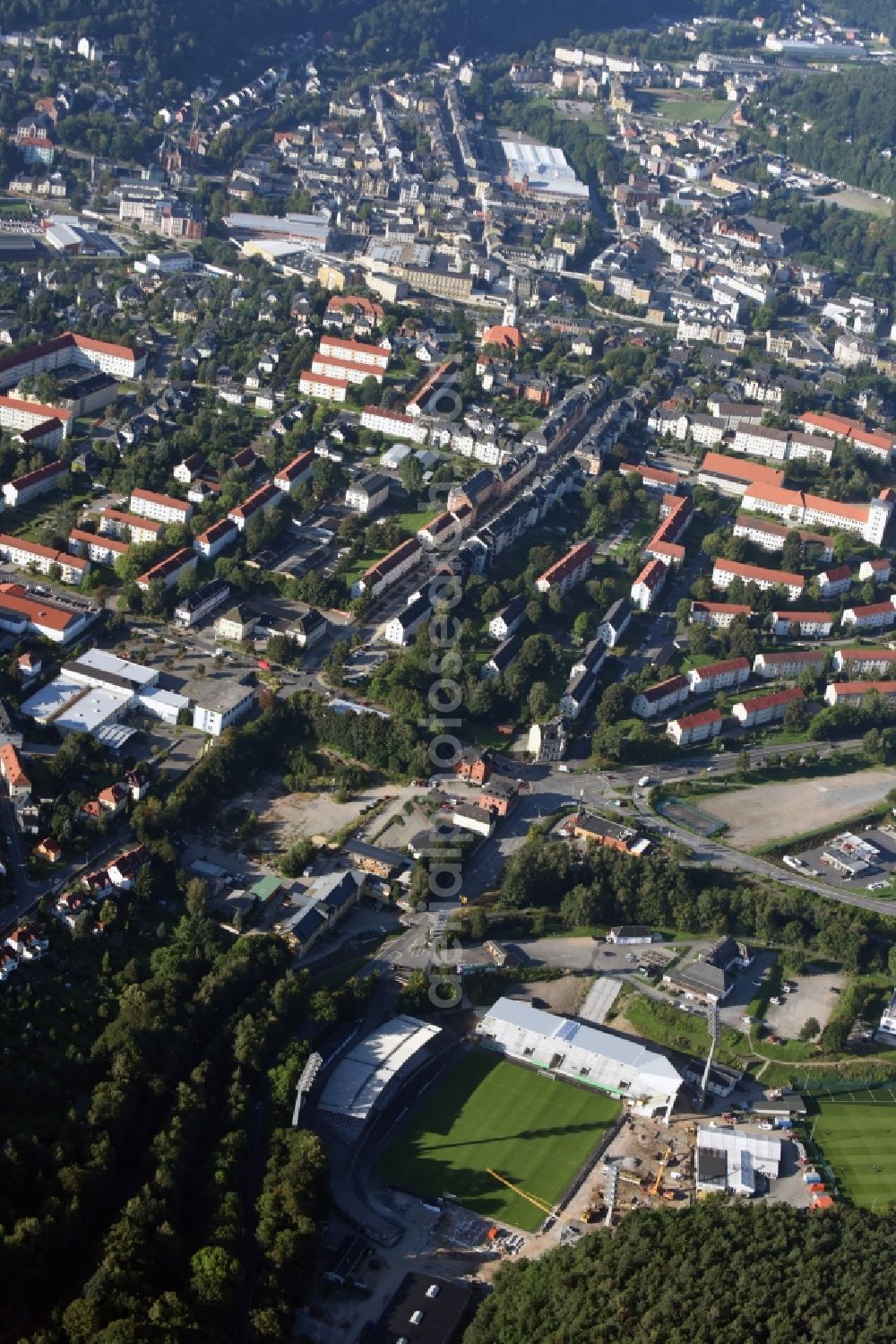 Aue from the bird's eye view: Construction for the reconstruction of the Sparkassen-Erzgebirgsstadium of the FC Aue at the Auer Strasse in Aue in the state Saxony. building owner is the Erzgebirgskreis. The working group Stadium Aue includes ASSMANN BERATEN + PLANEN GmbH, Buero bpp, Inros Lackner and Phase 10