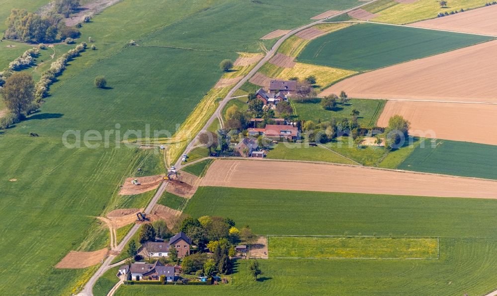 Emmerich am Rhein from the bird's eye view: Construction site for the renewal and rehabilitation of the road and Deiches of Deichstrasse in the district Dornick in Emmerich am Rhein in the state North Rhine-Westphalia, Germany