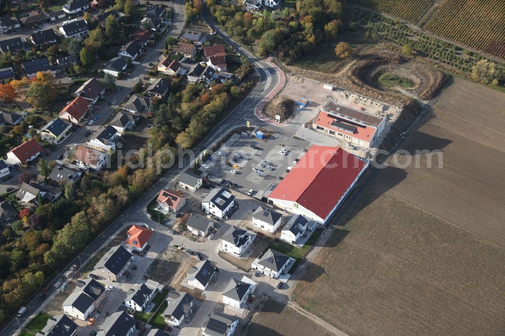 Gau-Bischofsheim from above - New construction site for the construction of a kindergarten building and Nursery school next to an Edeka food market, (red roof) in Gau-Bischofsheim in the state Rhineland-Palatinate, Germany