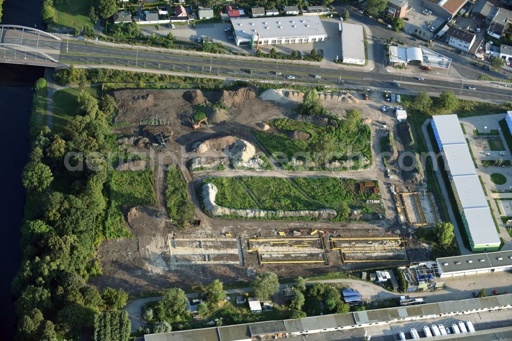 Berlin from above - Construction site of the extension of the asylum seekers accommodations on Haarlemer Strasse in the Britz part of the district of Neukoelln in Berlin. The area next to the asylum seekers and refugee buildings are being newly developed