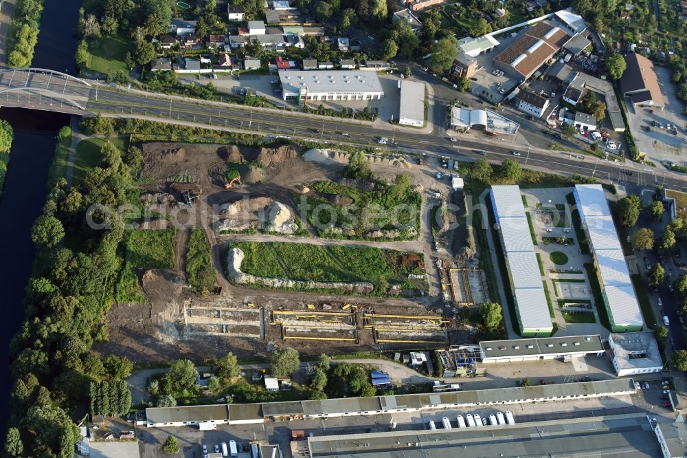 Berlin from the bird's eye view: Construction site of the extension of the asylum seekers accommodations on Haarlemer Strasse in the Britz part of the district of Neukoelln in Berlin. The area next to the asylum seekers and refugee buildings are being newly developed