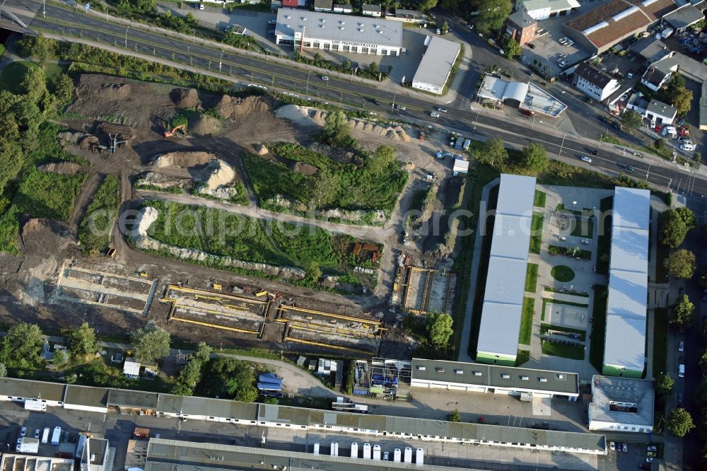 Aerial photograph Berlin - Construction site of the extension of the asylum seekers accommodations on Haarlemer Strasse in the Britz part of the district of Neukoelln in Berlin. The area next to the asylum seekers and refugee buildings are being newly developed