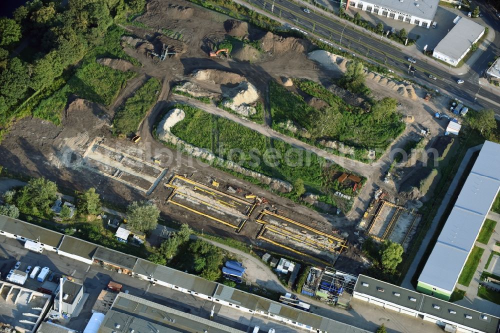 Berlin from the bird's eye view: Construction site of the extension of the asylum seekers accommodations on Haarlemer Strasse in the Britz part of the district of Neukoelln in Berlin. The area next to the asylum seekers and refugee buildings are being newly developed