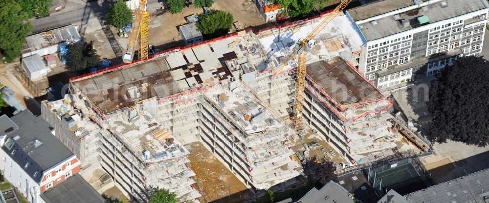 Hamburg from the bird's eye view: The construction site for the redevelopment of the Raven Street HanseMerkur AG in Hamburg. The redesign of the residential and commercial building complex with a daycare center and restaurant is designed by the Hamburg architectural firm Bothe Richter Teherani BRT Architects