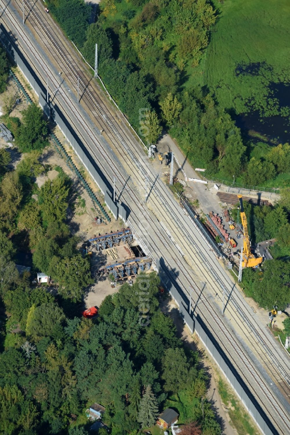 Berlin from the bird's eye view: Construction for the renovation of the railway bridge building to route the train tracks of Linie S3 between den Bahnhoefen Hirschgarten and Friedrichshagen beim Neuenhagener Muehlenfliess in Berlin, Germany