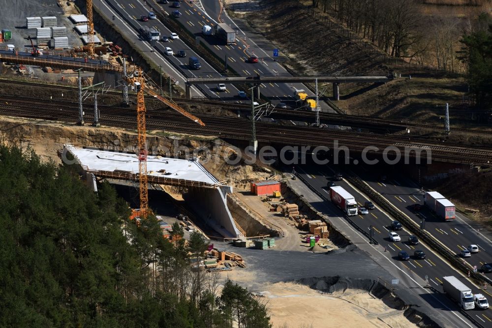 Michendorf from above - Construction for the renovation of the railway bridge building to route the train tracks crossing course of motorway BAB A10 in Michendorf in the state Brandenburg