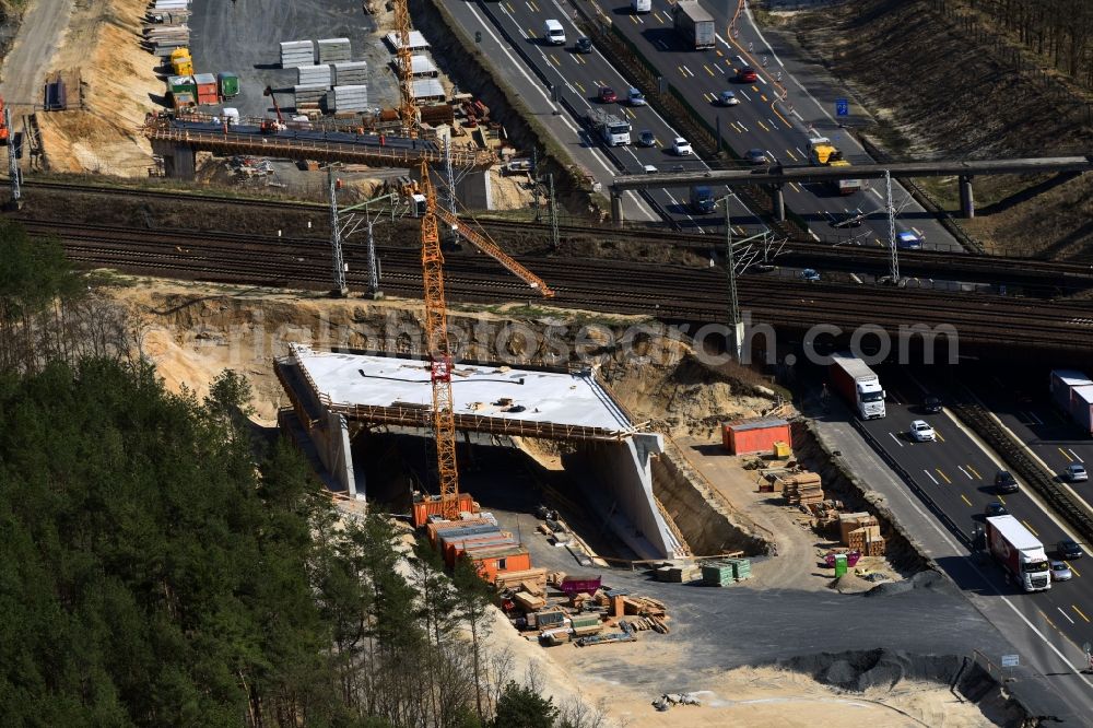 Michendorf from the bird's eye view: Construction for the renovation of the railway bridge building to route the train tracks crossing course of motorway BAB A10 in Michendorf in the state Brandenburg