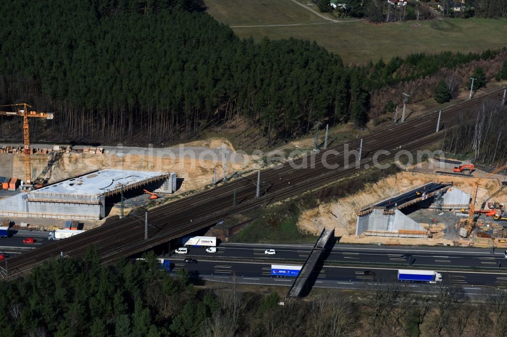 Michendorf from the bird's eye view: Construction for the renovation of the railway bridge building to route the train tracks crossing course of motorway BAB A10 in Michendorf in the state Brandenburg