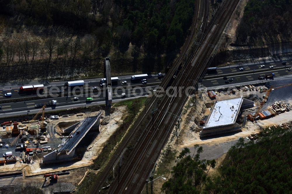 Aerial photograph Michendorf - Construction for the renovation of the railway bridge building to route the train tracks crossing course of motorway BAB A10 in Michendorf in the state Brandenburg