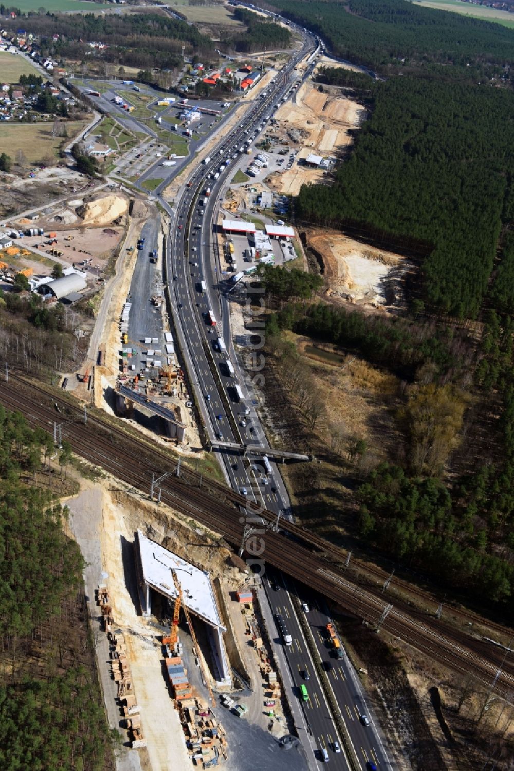 Michendorf from above - Construction for the renovation of the railway bridge building to route the train tracks crossing course of motorway BAB A10 in Michendorf in the state Brandenburg