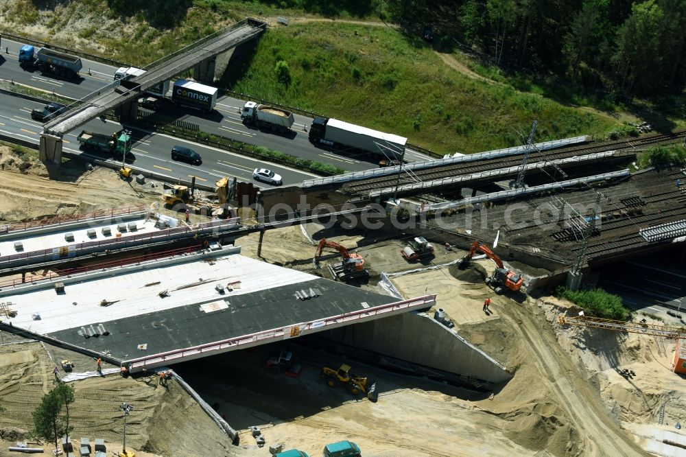 Aerial photograph Michendorf - Construction for the renovation of the railway bridge building to route the train tracks crossing course of motorway BAB A10 in Michendorf in the state Brandenburg