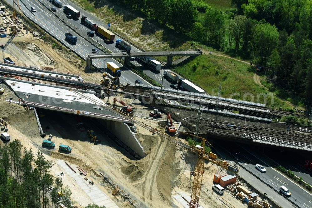 Michendorf from the bird's eye view: Construction for the renovation of the railway bridge building to route the train tracks crossing course of motorway BAB A10 in Michendorf in the state Brandenburg