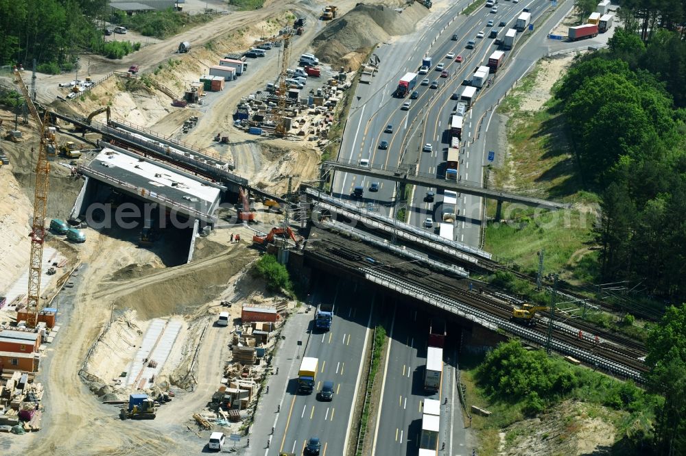 Michendorf from the bird's eye view: Construction for the renovation of the railway bridge building to route the train tracks crossing course of motorway BAB A10 in Michendorf in the state Brandenburg