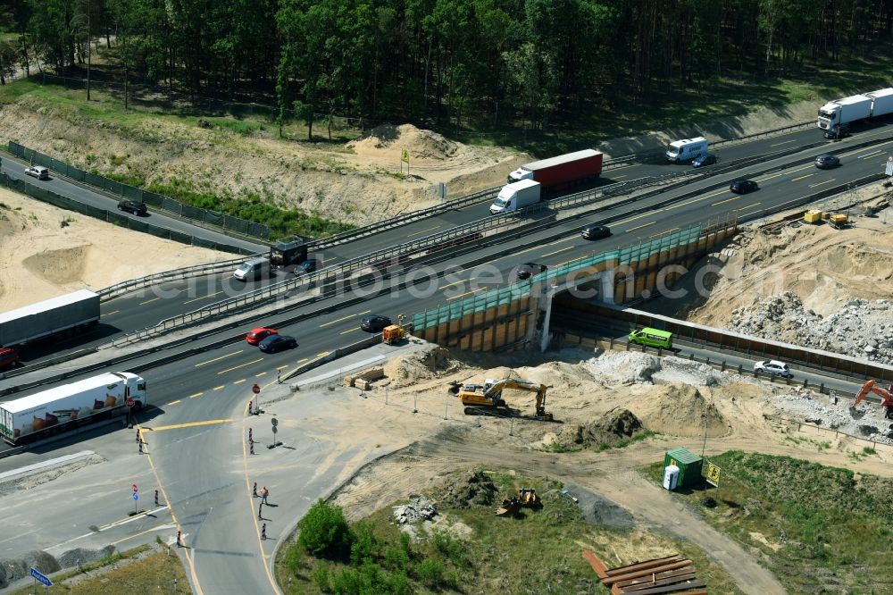 Michendorf from the bird's eye view: Construction for the renovation of the railway bridge building to route the train tracks crossing course of motorway BAB A10 in Michendorf in the state Brandenburg