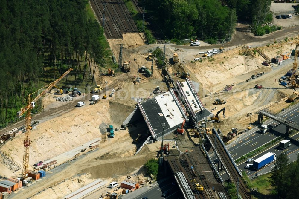 Aerial photograph Michendorf - Construction for the renovation of the railway bridge building to route the train tracks crossing course of motorway BAB A10 in Michendorf in the state Brandenburg