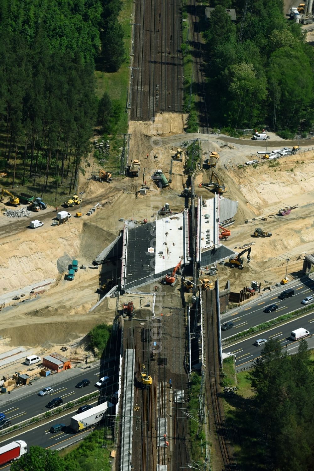 Michendorf from the bird's eye view: Construction for the renovation of the railway bridge building to route the train tracks crossing course of motorway BAB A10 in Michendorf in the state Brandenburg