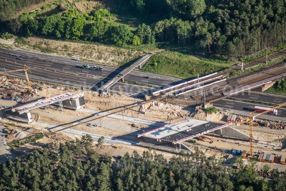 Aerial image Michendorf - Construction for the renovation of the railway bridge building to route the train tracks crossing course of motorway BAB A10 in Michendorf in the state Brandenburg