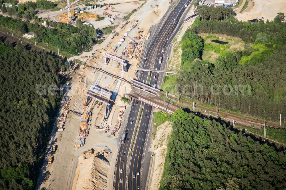 Michendorf from the bird's eye view: Construction for the renovation of the railway bridge building to route the train tracks crossing course of motorway BAB A10 in Michendorf in the state Brandenburg