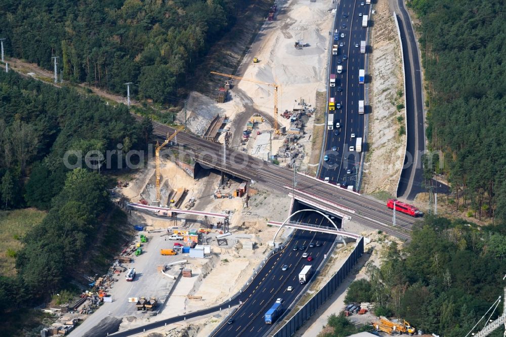 Aerial image Michendorf - Construction for the renovation of the railway bridge building to route the train tracks crossing course of motorway BAB A10 in Michendorf in the state Brandenburg