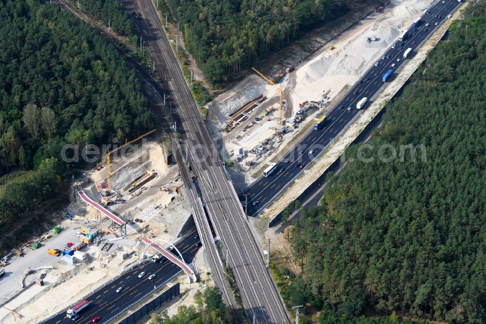 Michendorf from the bird's eye view: Construction for the renovation of the railway bridge building to route the train tracks crossing course of motorway BAB A10 in Michendorf in the state Brandenburg