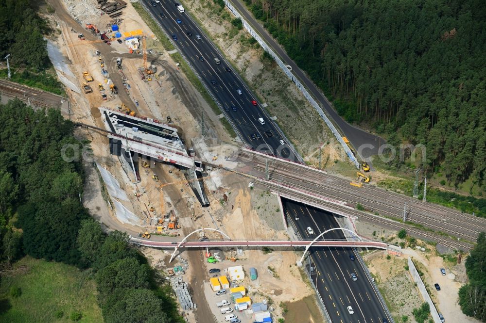 Michendorf from the bird's eye view: Construction for the renovation of the railway bridge building to route the train tracks crossing course of motorway BAB A10 in Michendorf in the state Brandenburg