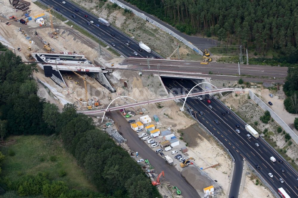 Aerial photograph Michendorf - Construction for the renovation of the railway bridge building to route the train tracks crossing course of motorway BAB A10 in Michendorf in the state Brandenburg