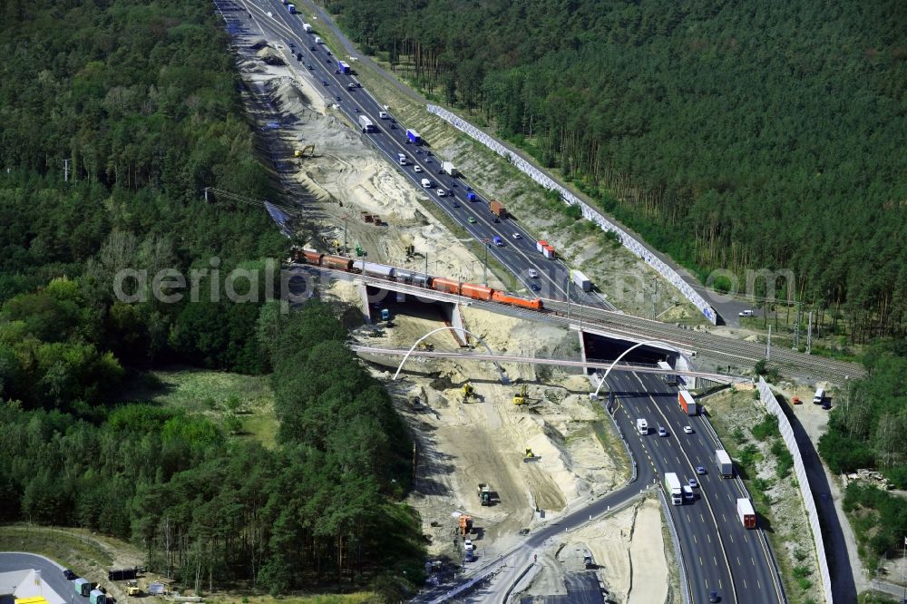 Michendorf from the bird's eye view: Construction for the renovation of the railway bridge building to route the train tracks crossing course of motorway BAB A10 in Michendorf in the state Brandenburg