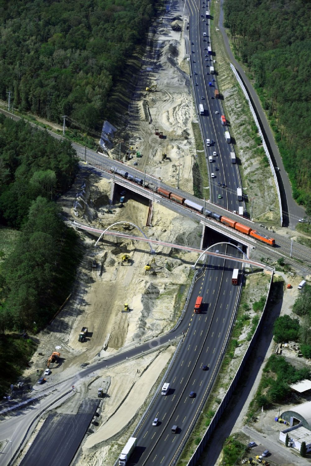 Michendorf from above - Construction for the renovation of the railway bridge building to route the train tracks crossing course of motorway BAB A10 in Michendorf in the state Brandenburg