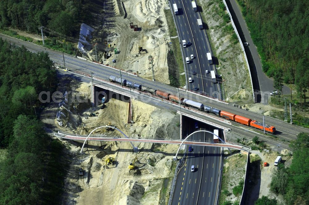 Michendorf from the bird's eye view: Construction for the renovation of the railway bridge building to route the train tracks crossing course of motorway BAB A10 in Michendorf in the state Brandenburg