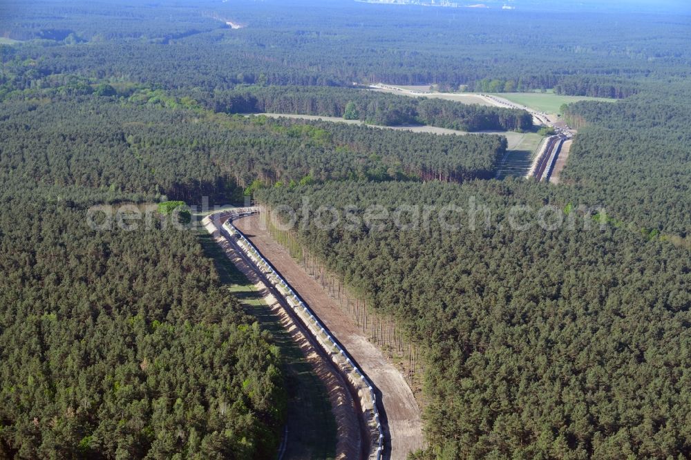 Teupitz from the bird's eye view: Construction site with earthworks and landfills for the laying of pipelines of the new European Gas Lines (Eugal) in a forest in einem Wald in Gross Koeris in the state Brandenburg, Germany