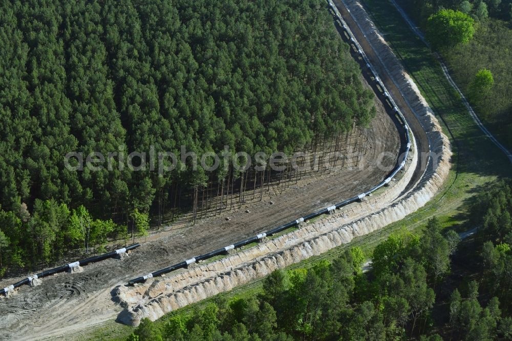 Teupitz from the bird's eye view: Construction site with earthworks and landfills for the laying of pipelines of the new European Gas Lines (Eugal) in a forest in einem Wald in Gross Koeris in the state Brandenburg, Germany