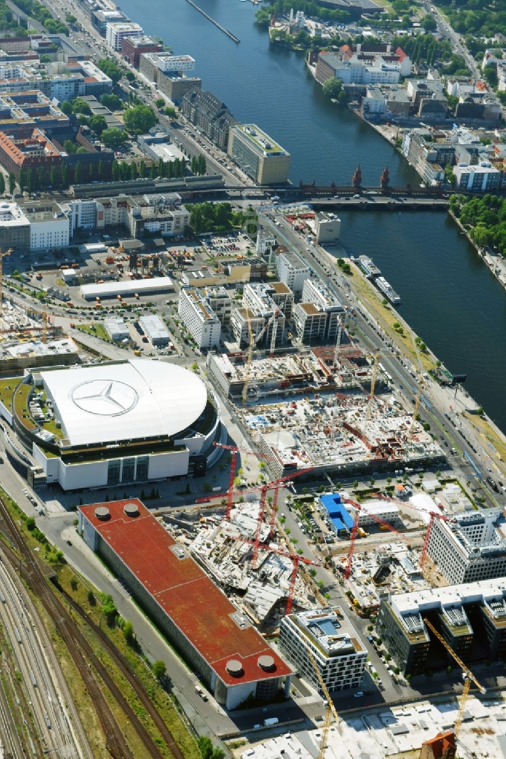 Berlin from above - Development area and construction sites on the Anschutzareal at the Mercedes-Benz-Arena on the banks of the River Spree in Friedrichshain. The Anschutz Entertainment Group (AEG) is developing the site through numerous hotel and commercial building new buildings